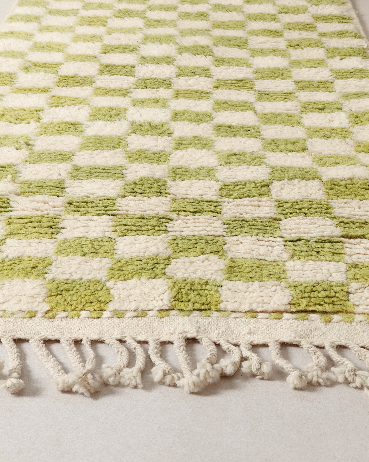Green checkerboard rug, close