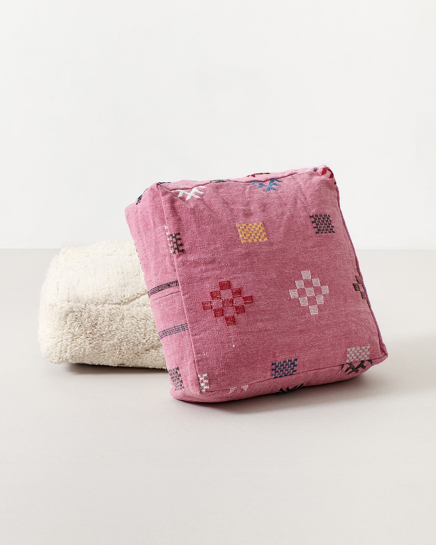 Pink pouf with colourful pictograms