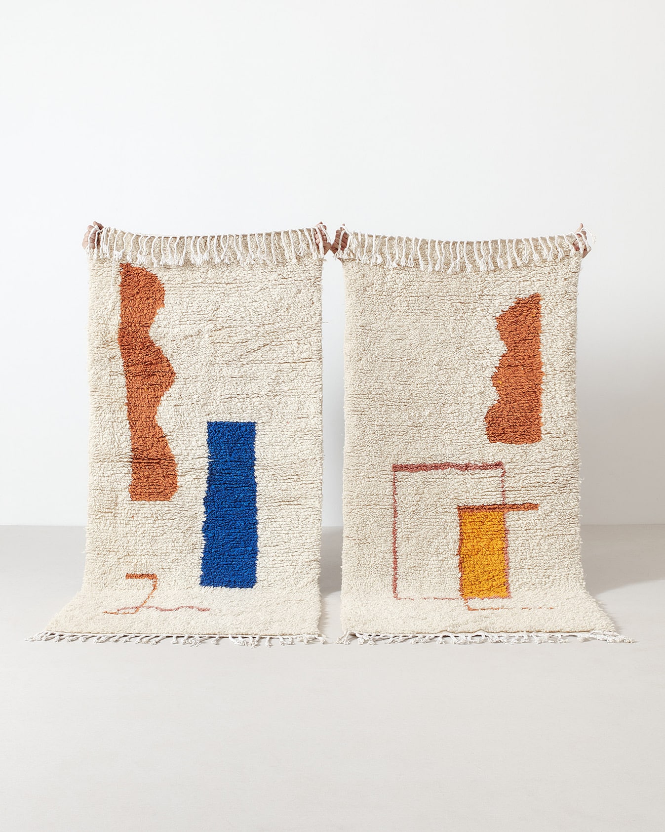 Berber rug with cinnamon and royal blue shapes and Berber rug with cinnamon and ochre shapes