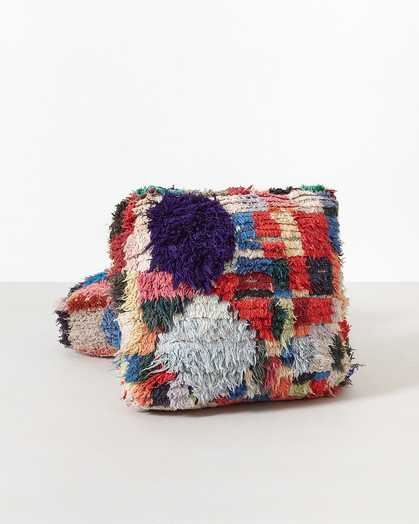 Colourful, long-pile vintage pouf