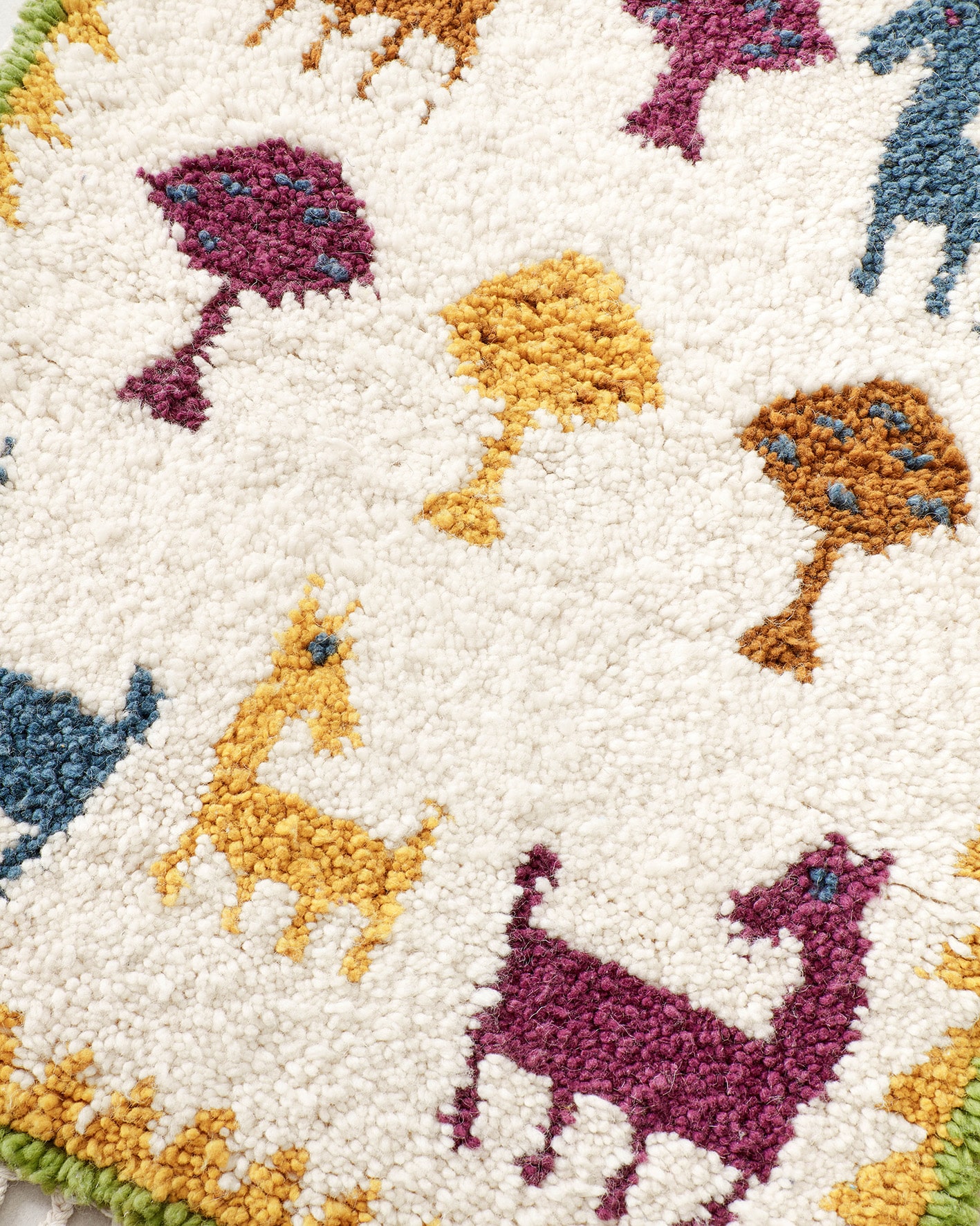 Tiny animal rug in joyful colours, close