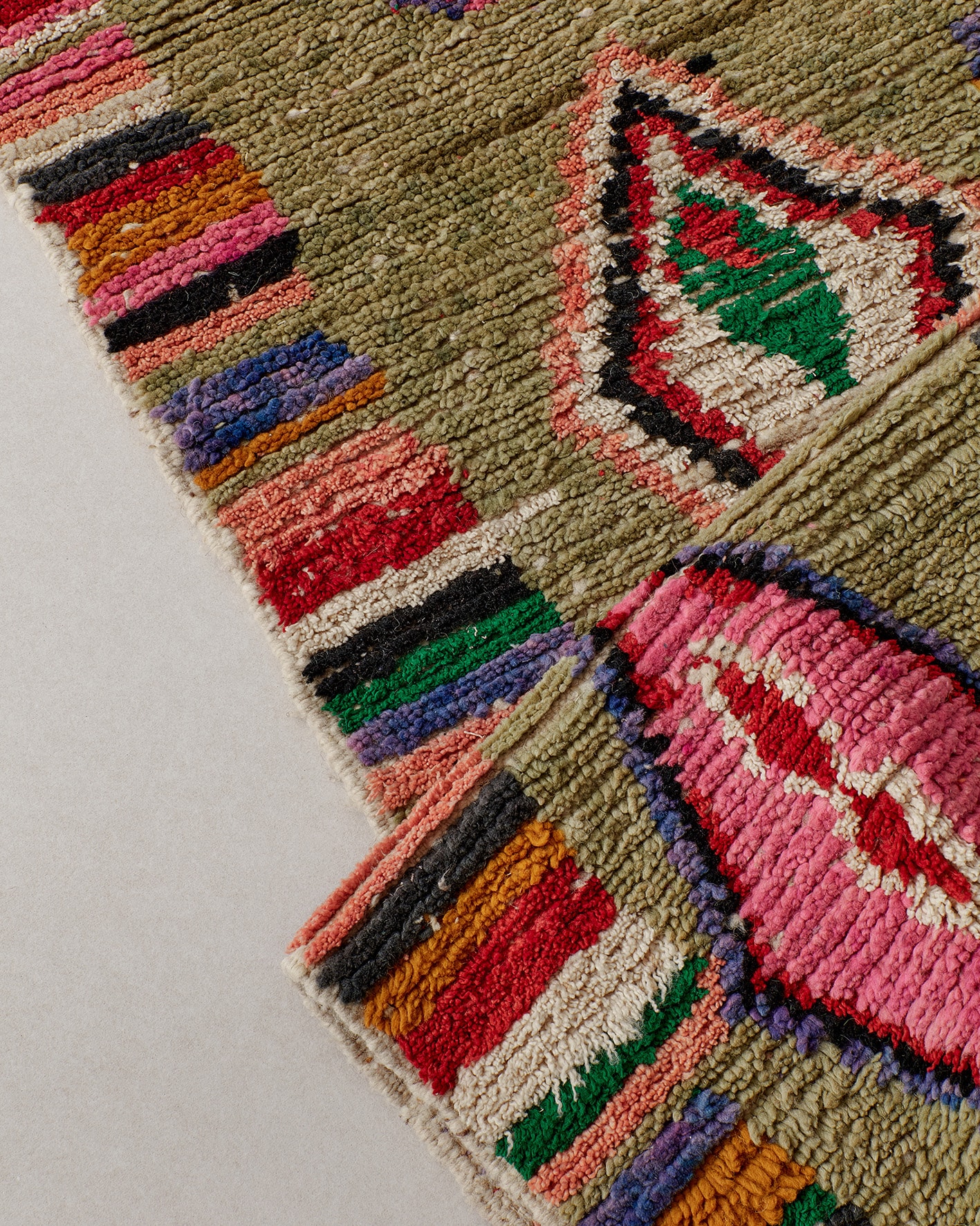 Olive green runner with colourful details, texture