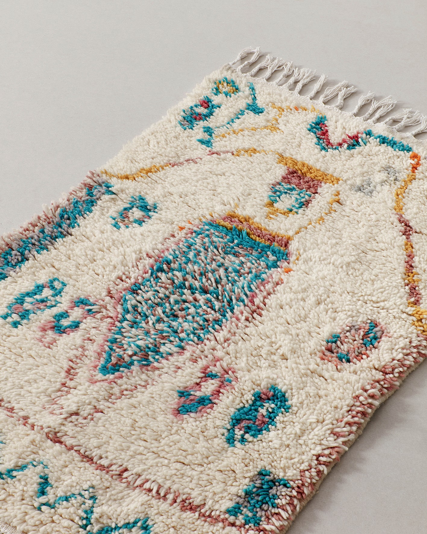 Tiny rug with turquoise motifs, close