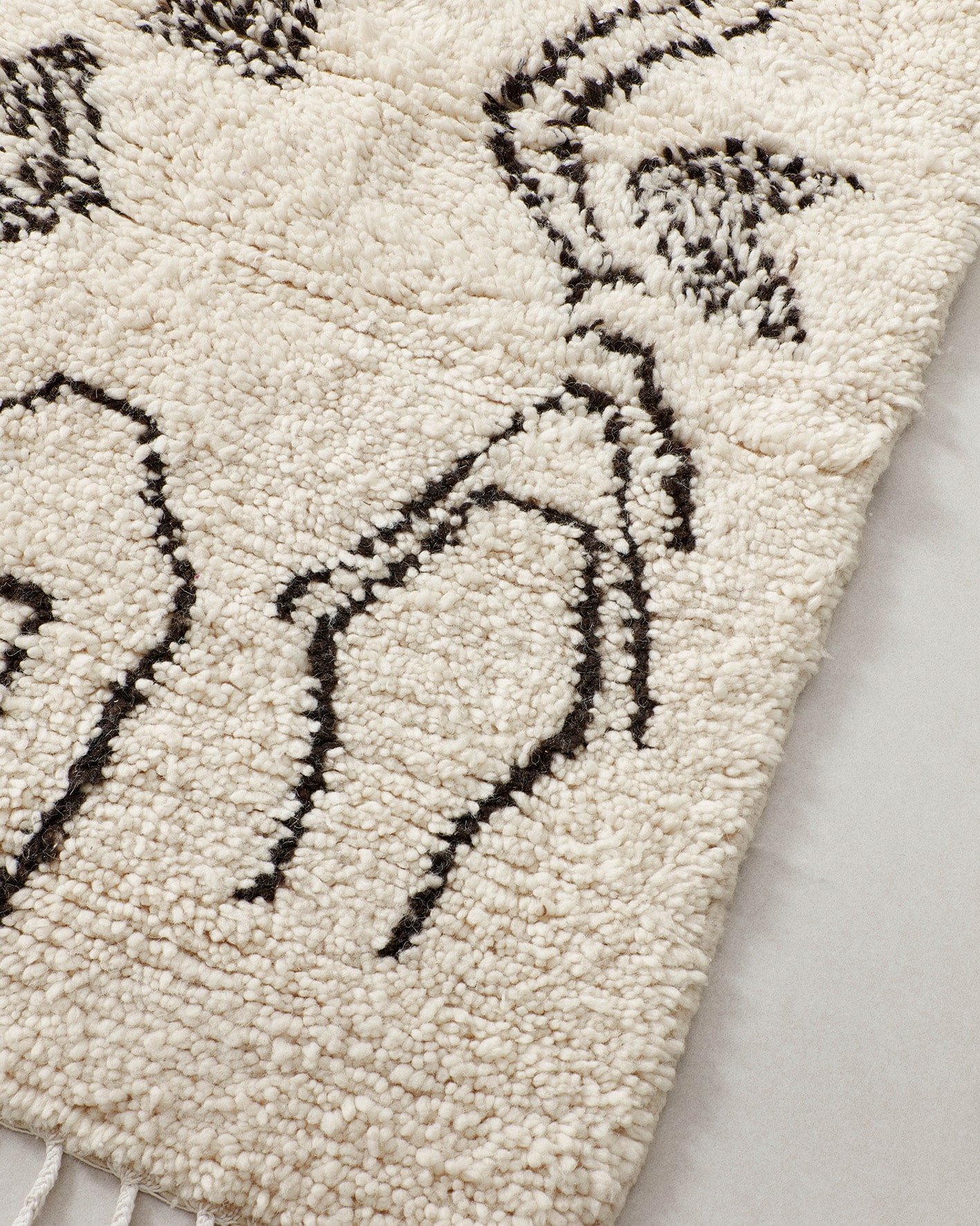 Tiny rug with abstract line drawings, close
