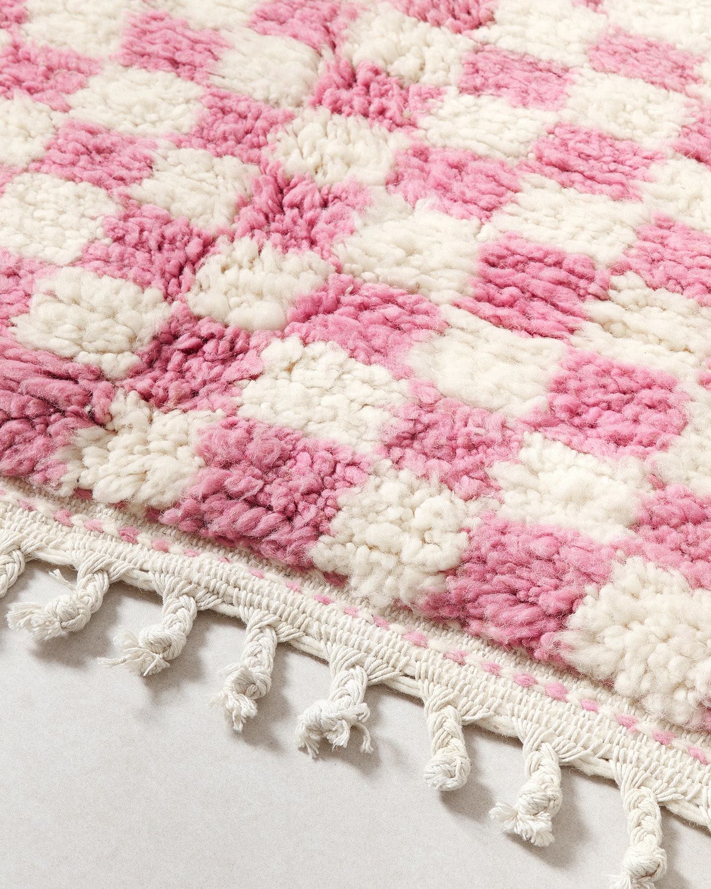 Pink checkered rug, fringe