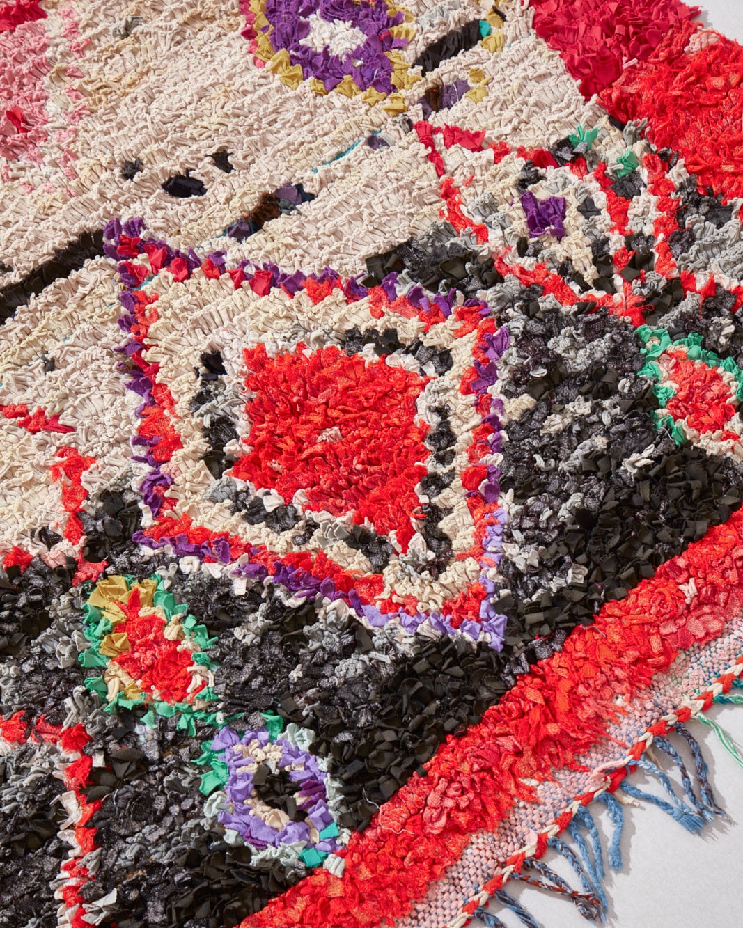 Boucherouite rug with diamonds and red border, fringe