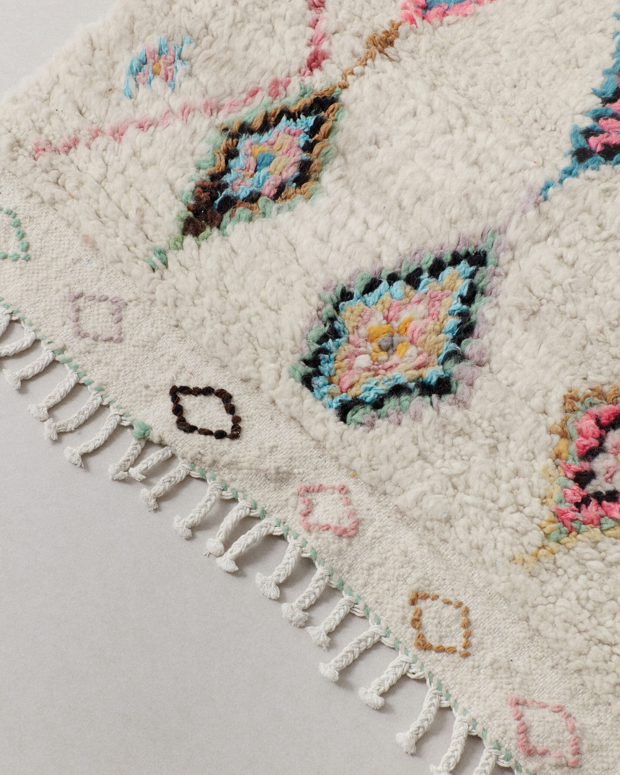 Little rug with colourful diamonds , fringes