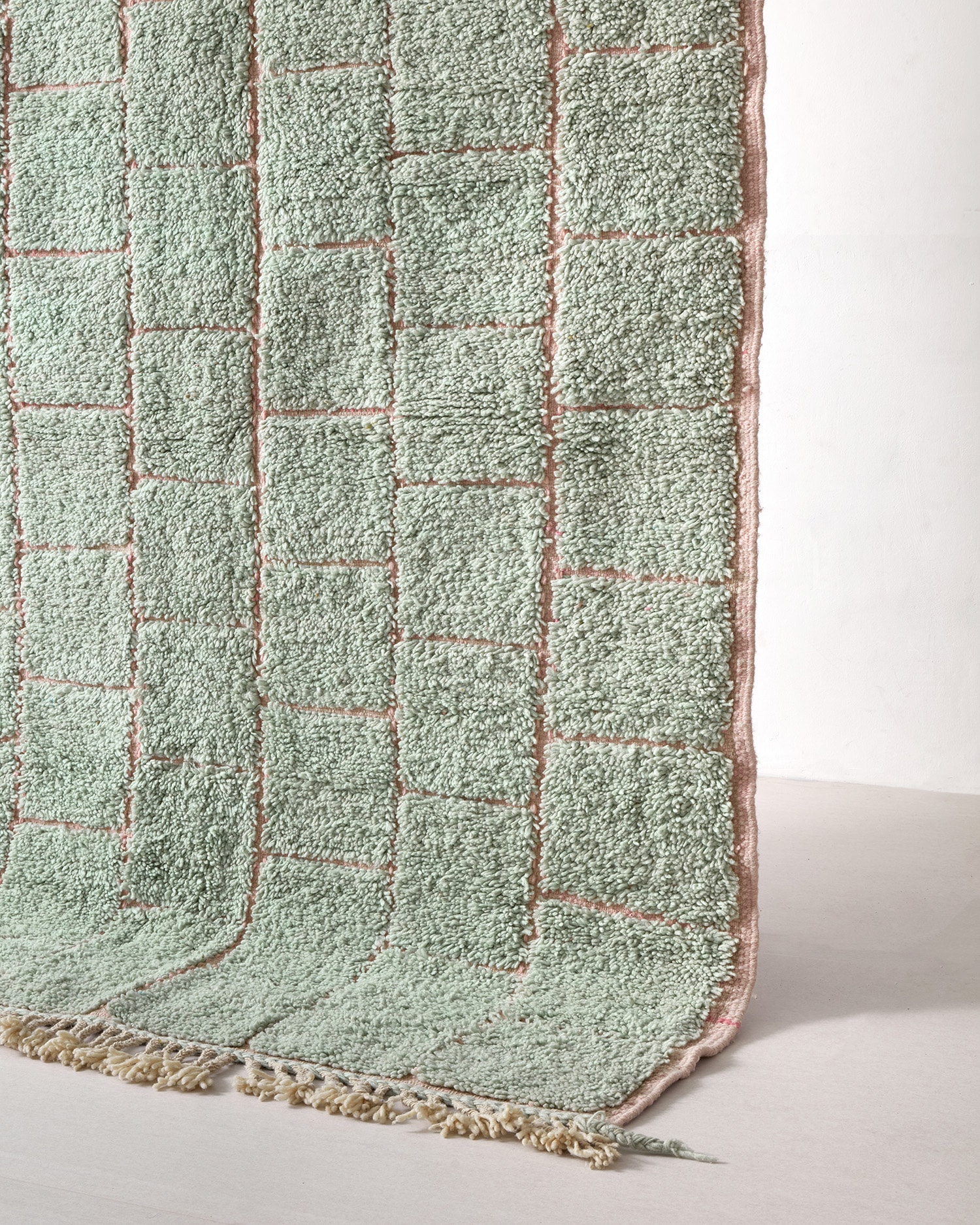 Mint-coloured rug with pink flatwoven pattern